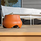 Polk Atrium Sub100 Outdoor-Subwoofer – Terrakotta auf einer Holzterrasse